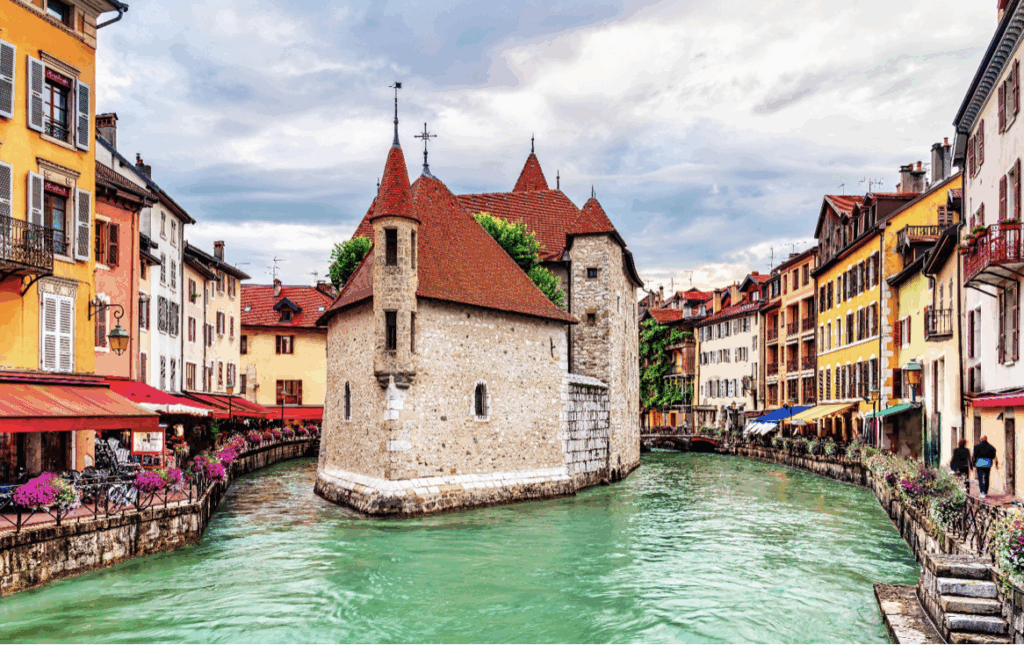 The town of Annecy with it's famous building in a lake in the French Alps
