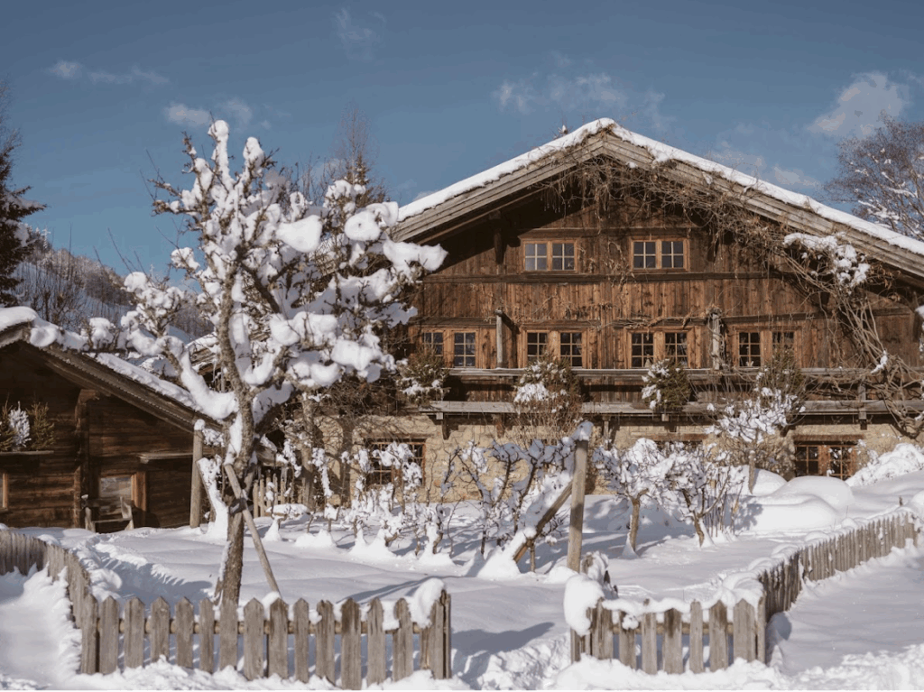A winter chalet is covered in snow in the French Alps