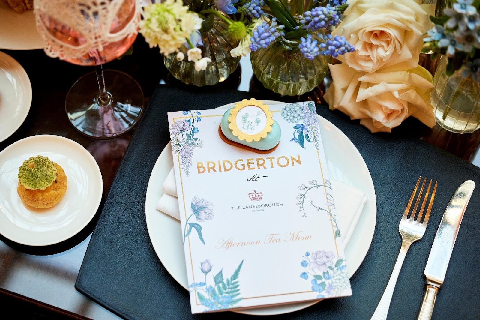 Bridgerton-themed afternoon tea menu at The Lanesborough London with elegant place setting, pastries, and floral arrangements.