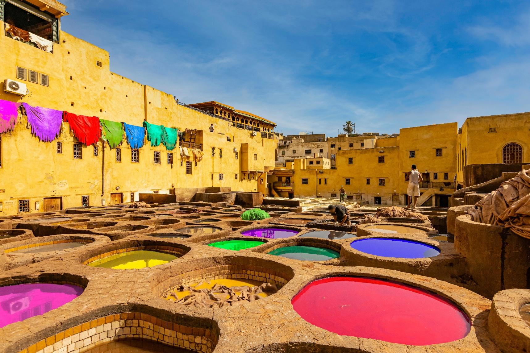 Colorful leather dye vats in the Fez tanneries, capturing Morocco’s rich craftsmanship and authentic luxury cultural experience.